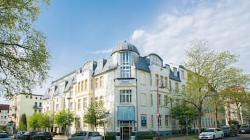 A hotel with a classic architectural style, featuring a prominent dome and multiple windows.