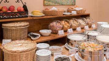 A buffet with various food items including fruits, cereals, and dairy products.