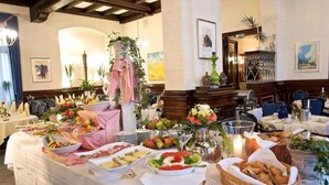 A buffet setup with various food items and a decorative centerpiece. - Hotel Deutsches Haus (Braunschweig)