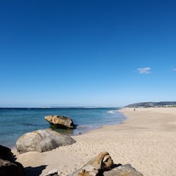 On the beach, white sand, beach towels, beach volleyball