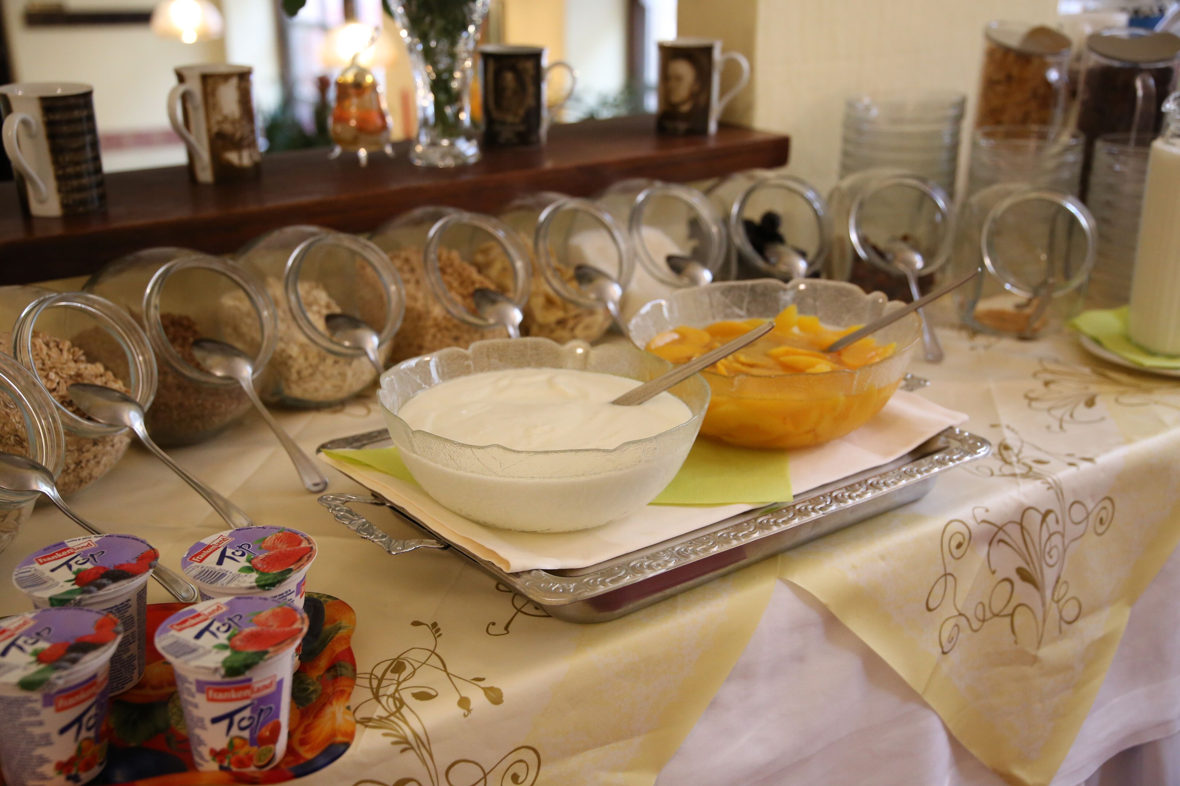 A breakfast buffet with various food items and containers.