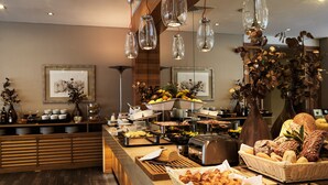 A buffet setup with various food items and a coffee machine. - Galaxy Hotel Iraklio (Heraklion)