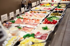 A buffet with various food options including meats, cheeses, and fruits. - City Partner Hotel Berliner Hof (Karlsruhe)