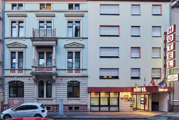 A hotel facade with multiple windows, a prominent sign, and a car parked in front. - City Partner Hotel Berliner Hof (Karlsruhe)