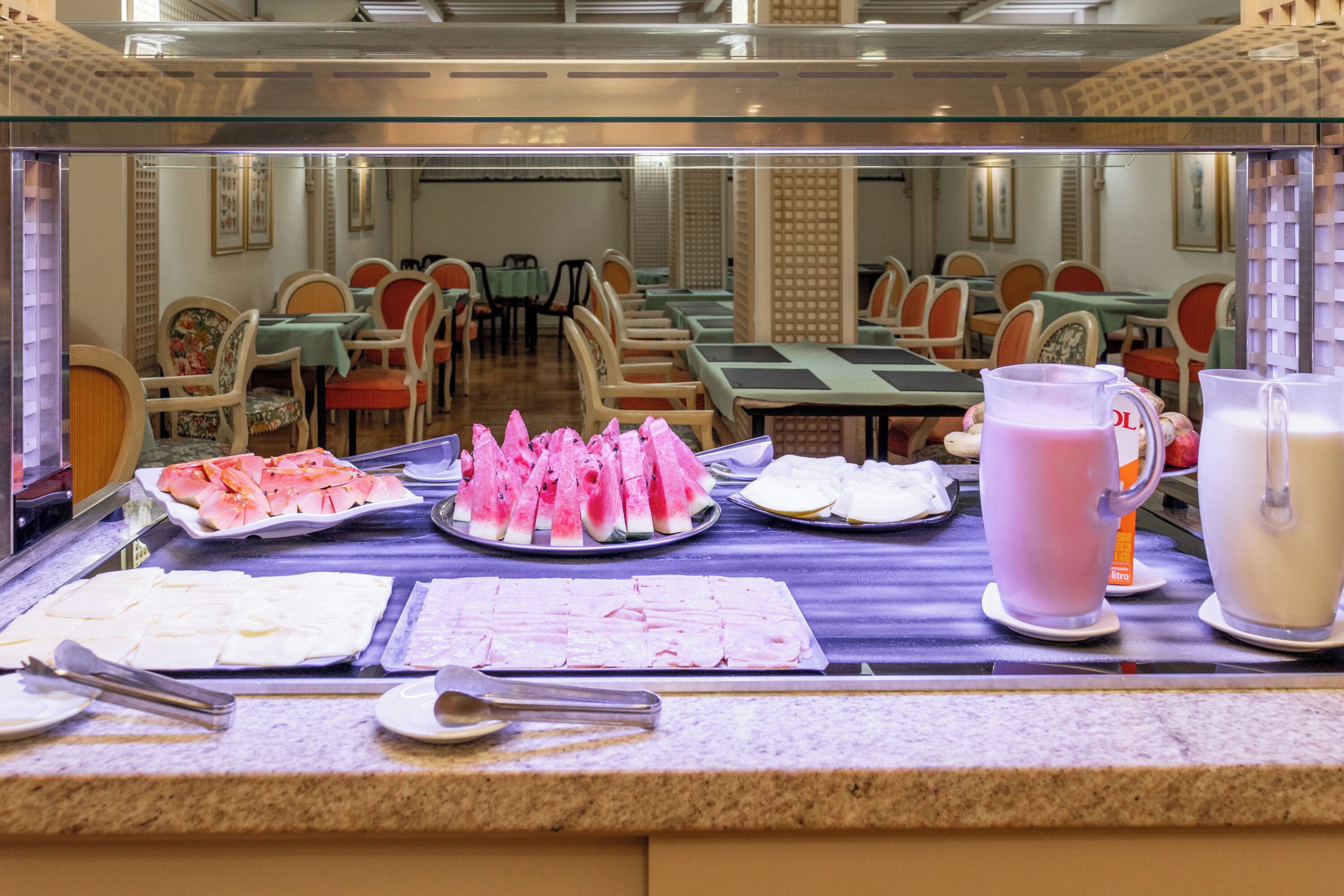 A buffet with various food items and drinks.