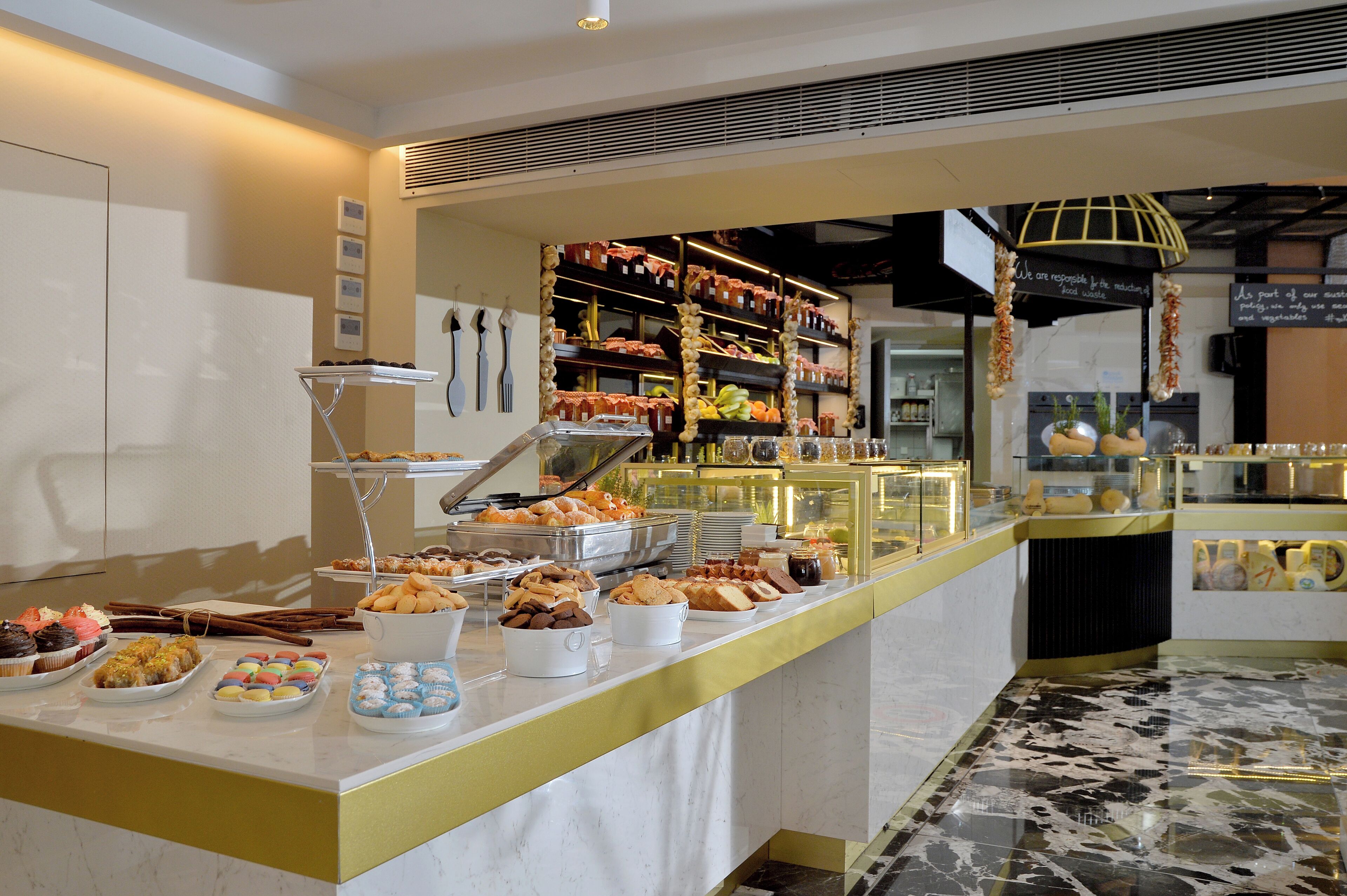 A buffet with various food items and a display case.