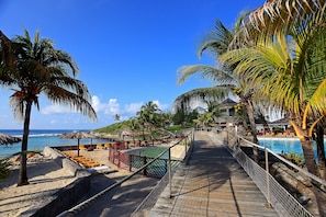 On the beach, white sand, sun loungers, beach bar