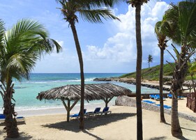 On the beach, white sand, sun loungers, beach bar