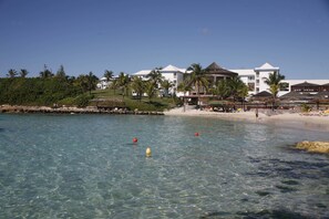 On the beach, white sand, sun loungers, beach bar