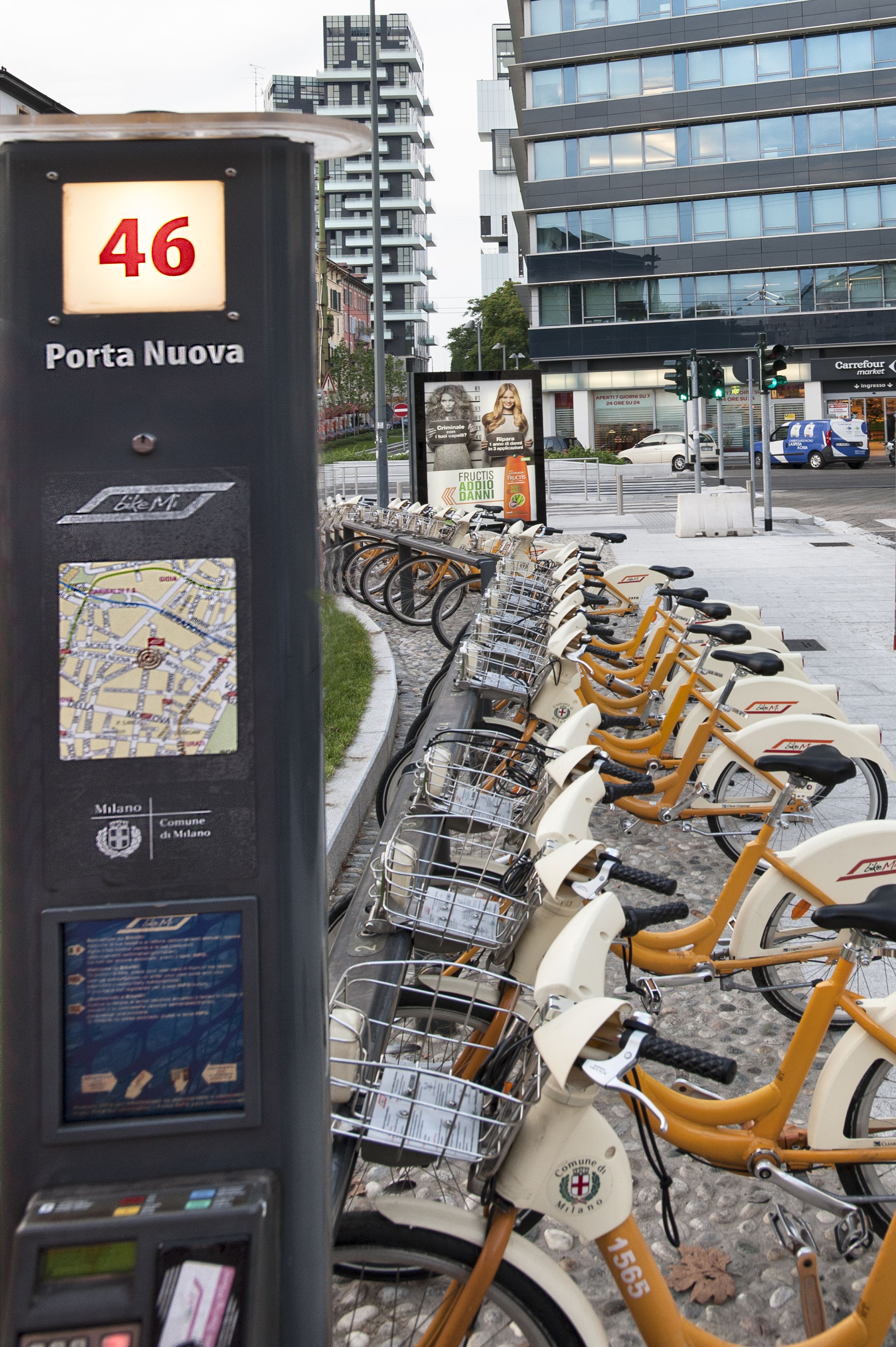 A bike rental station with a map and a sign indicating 'Porta Nuova'.