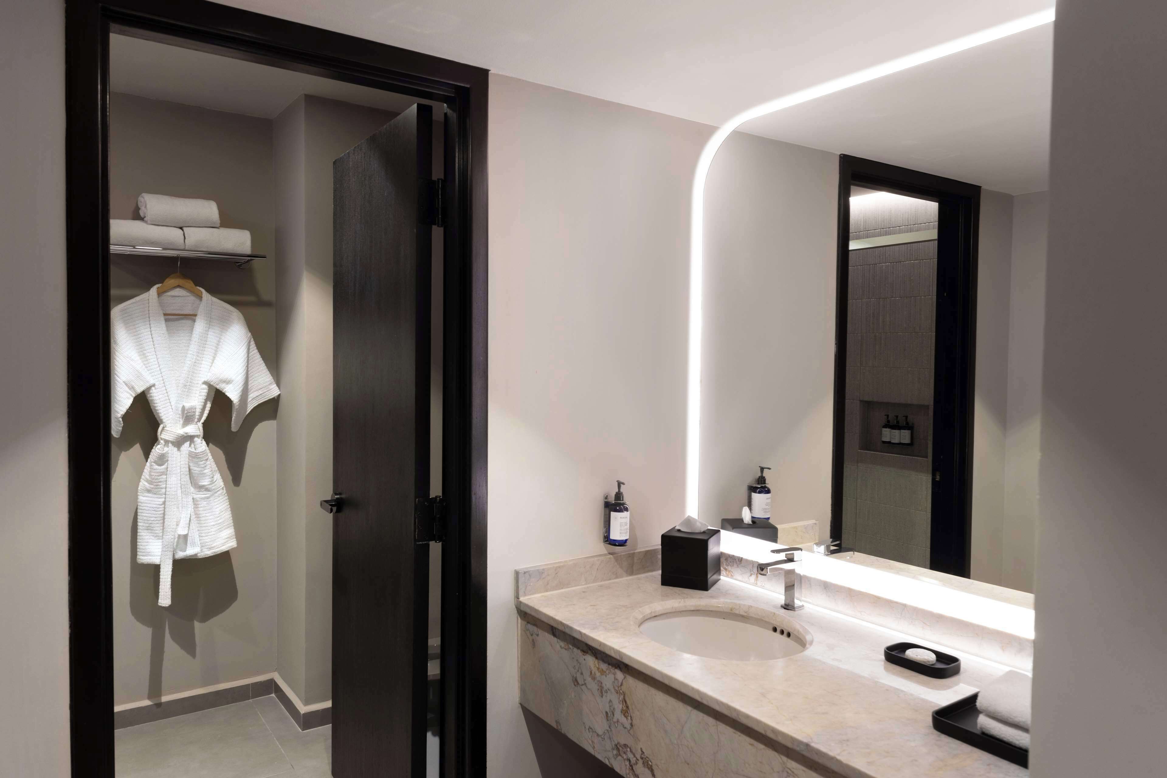 bathtub, designer toiletries, hair dryer, towels