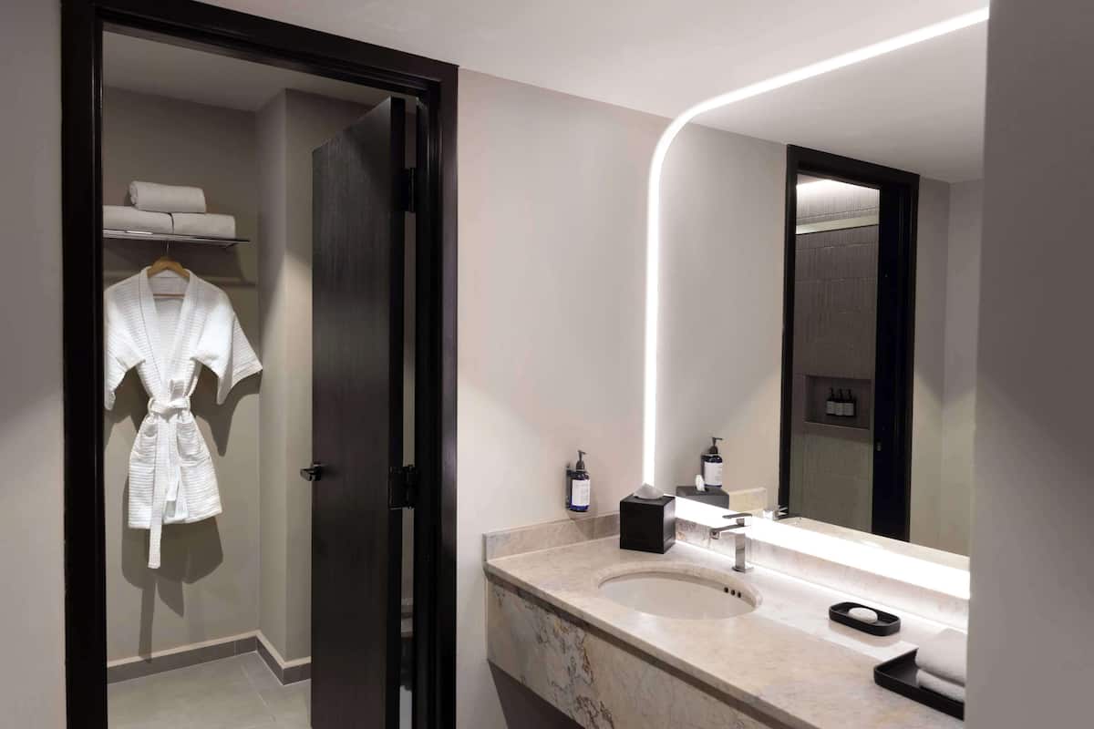 bathtub, designer toiletries, hair dryer, towels