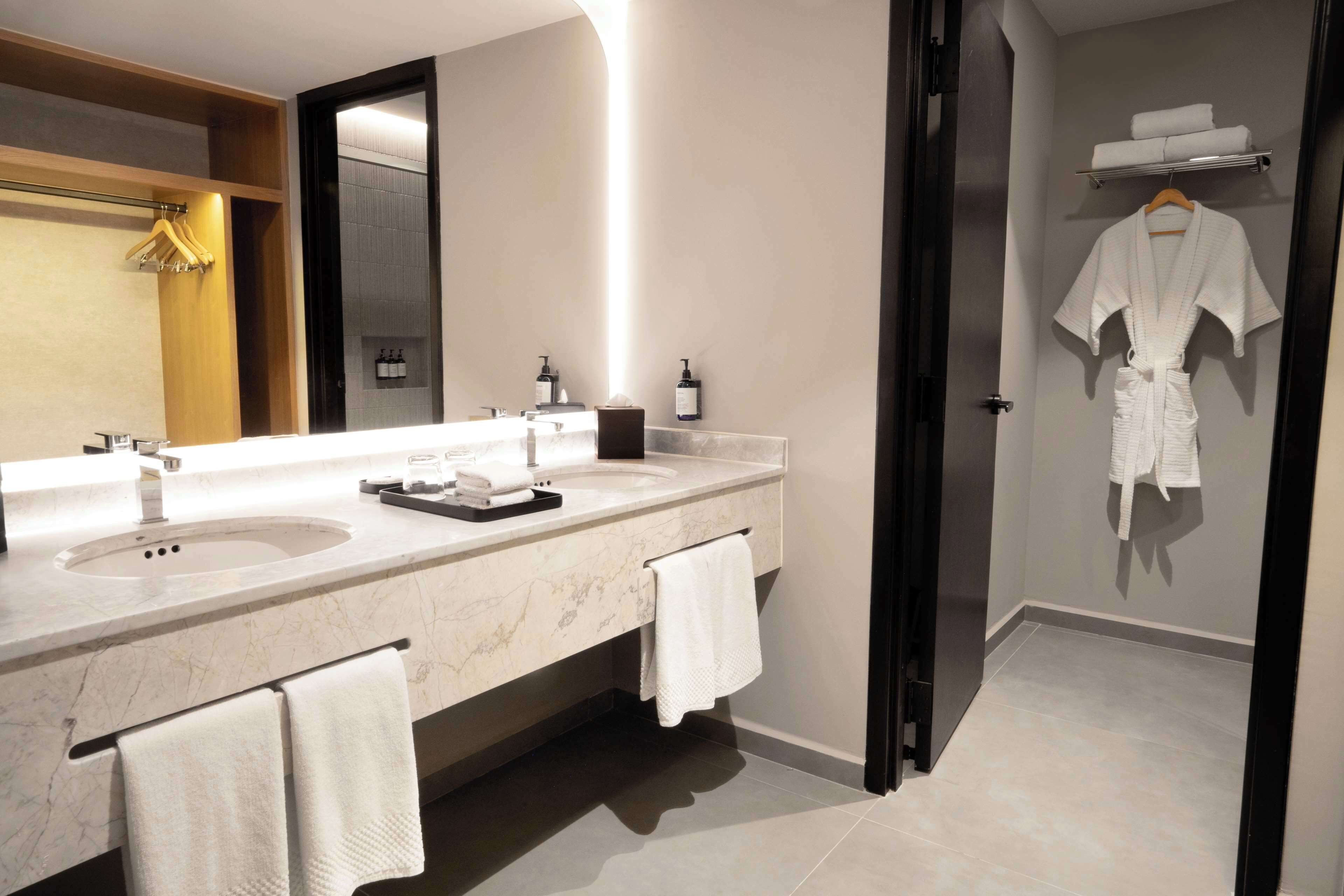 bathtub, designer toiletries, hair dryer, towels