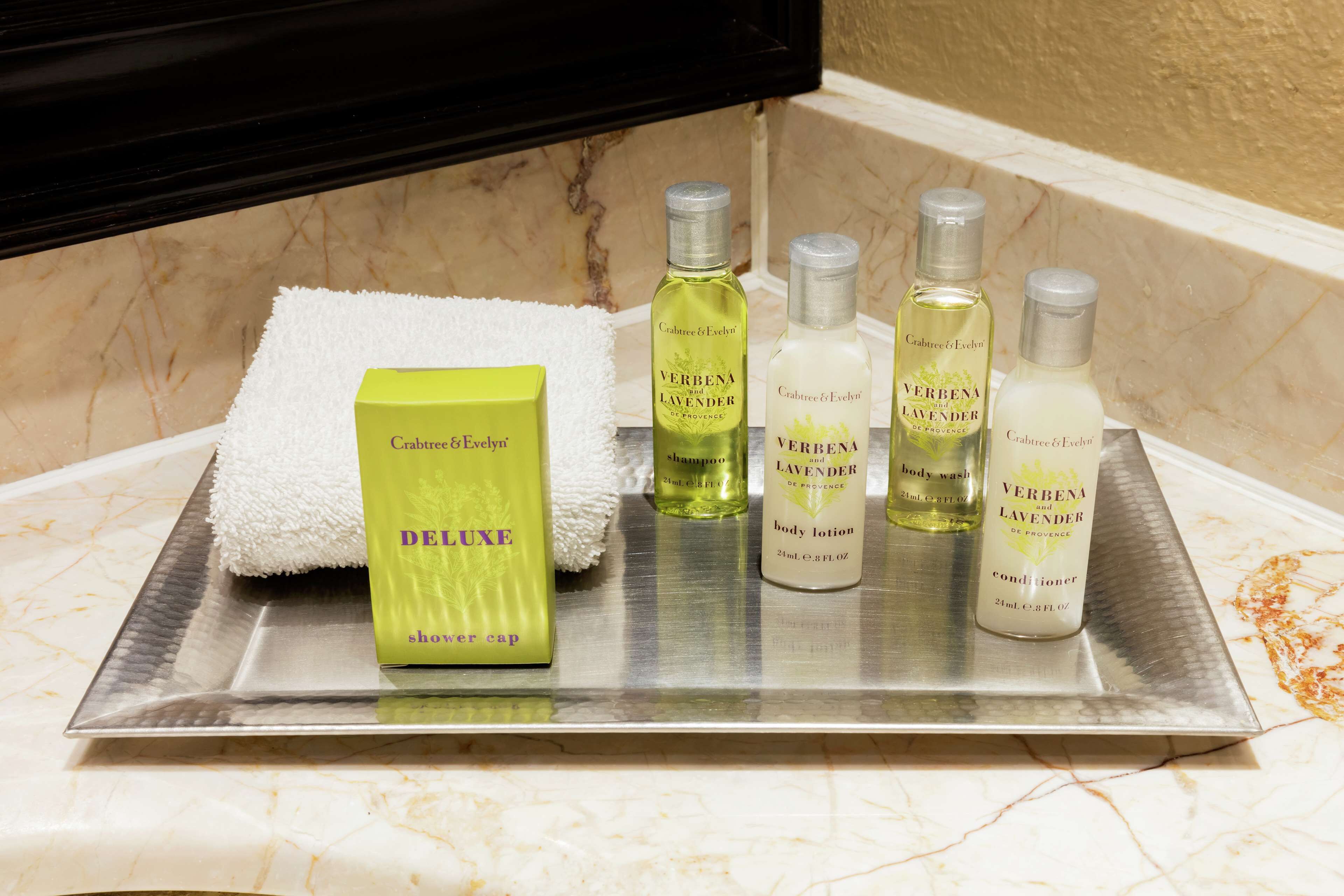 bathtub, designer toiletries, hair dryer, towels