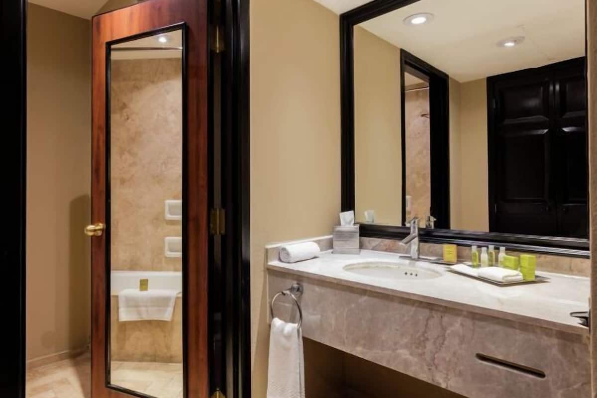 Bathtub, designer toiletries, hair dryer, towels