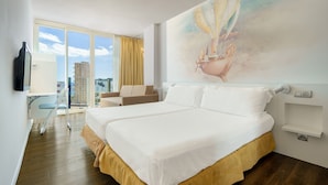 A hotel room with a large bed, a desk, a chair, and a balcony with a city view. - Sol Katmandu Park & Resort (Calvia)