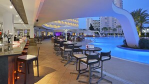 A modern outdoor bar area with seating and a pool. - Sol Guadalupe (Calvia)