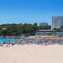 On the beach, white sand, sun-loungers, beach umbrellas