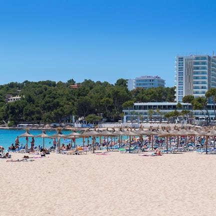 On the beach, white sand, sun loungers, beach umbrellas