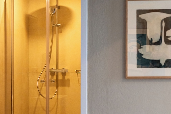 Shower, hair dryer, slippers, towels