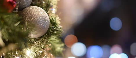 A close-up of a Christmas tree with ornaments and lights.