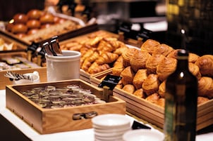 A buffet with various pastries, including croissants and a selection of chocolates.