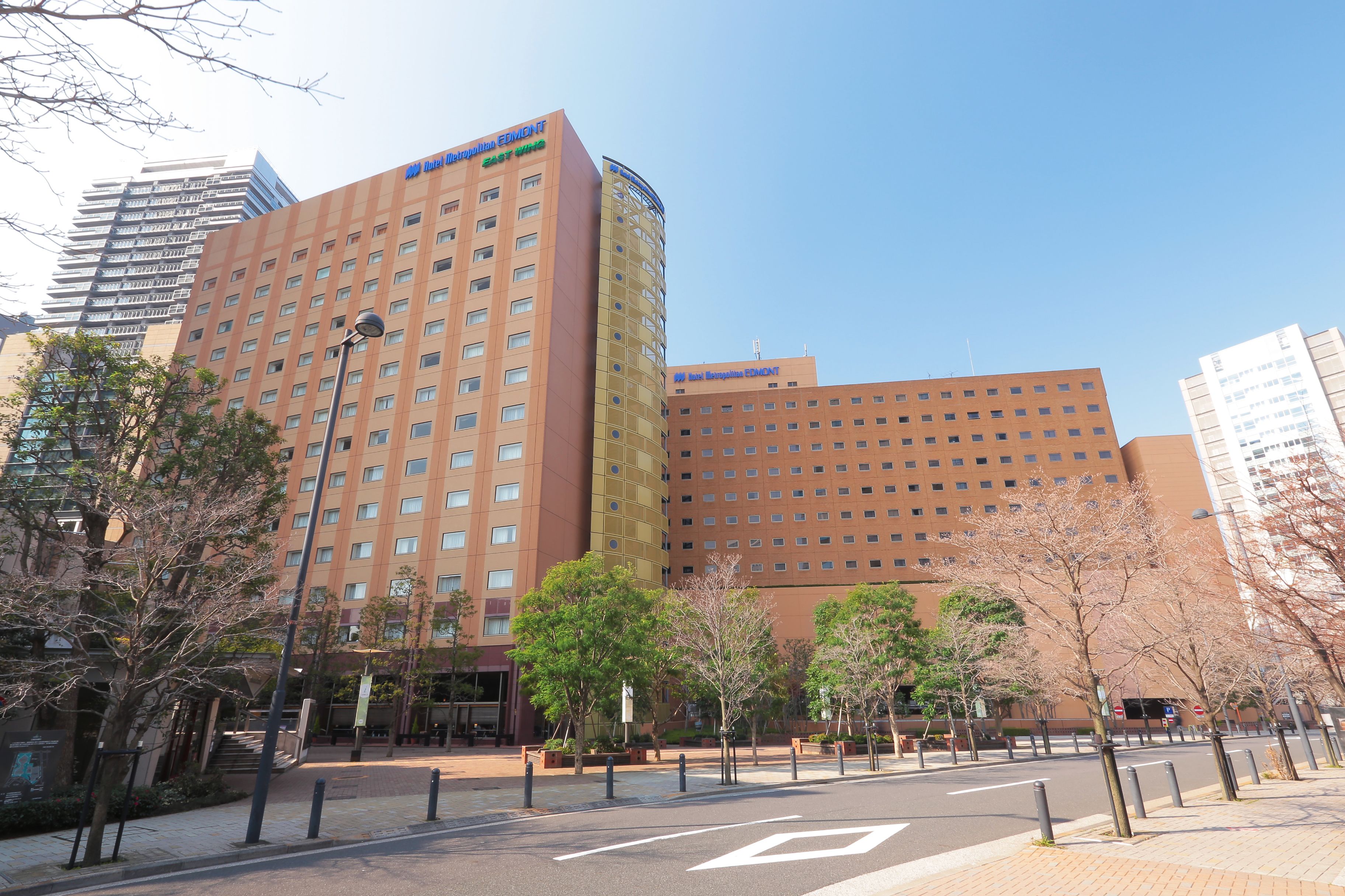 A hotel with a modern design, featuring a prominent entrance and multiple floors.