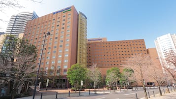 A hotel with a modern design, featuring a prominent entrance and multiple floors.