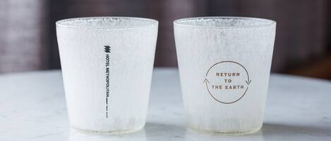Two glass tumblers with text on them.