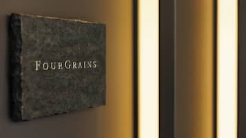 A dark textured wall with the inscription "FOURGRANS" in capital letters.