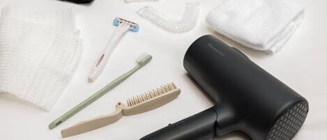 A collection of personal care items including a hair dryer, combs, and a razor.