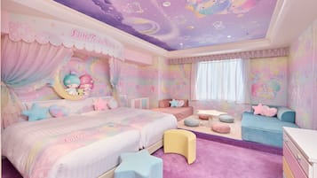 A bedroom with a bed, a sofa, a desk, and a window.