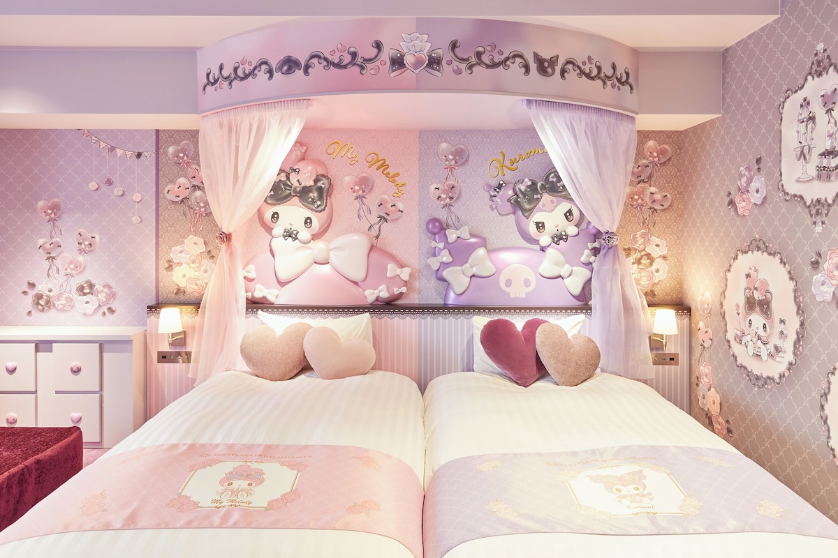 Een slaapkamer met twee bedden, een hemelbed en een kaptafel met spiegel.