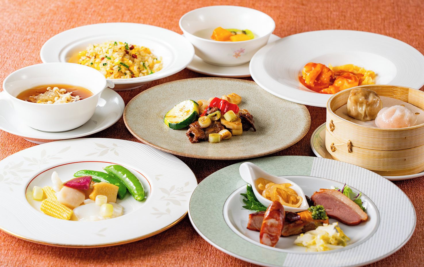 A variety of dishes on different plates and bowls, suggesting a meal setting.