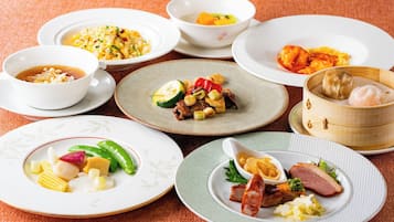 A variety of dishes on different plates and bowls, suggesting a meal setting.