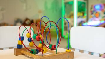 A wooden abacus with colorful beads and wires on a table.