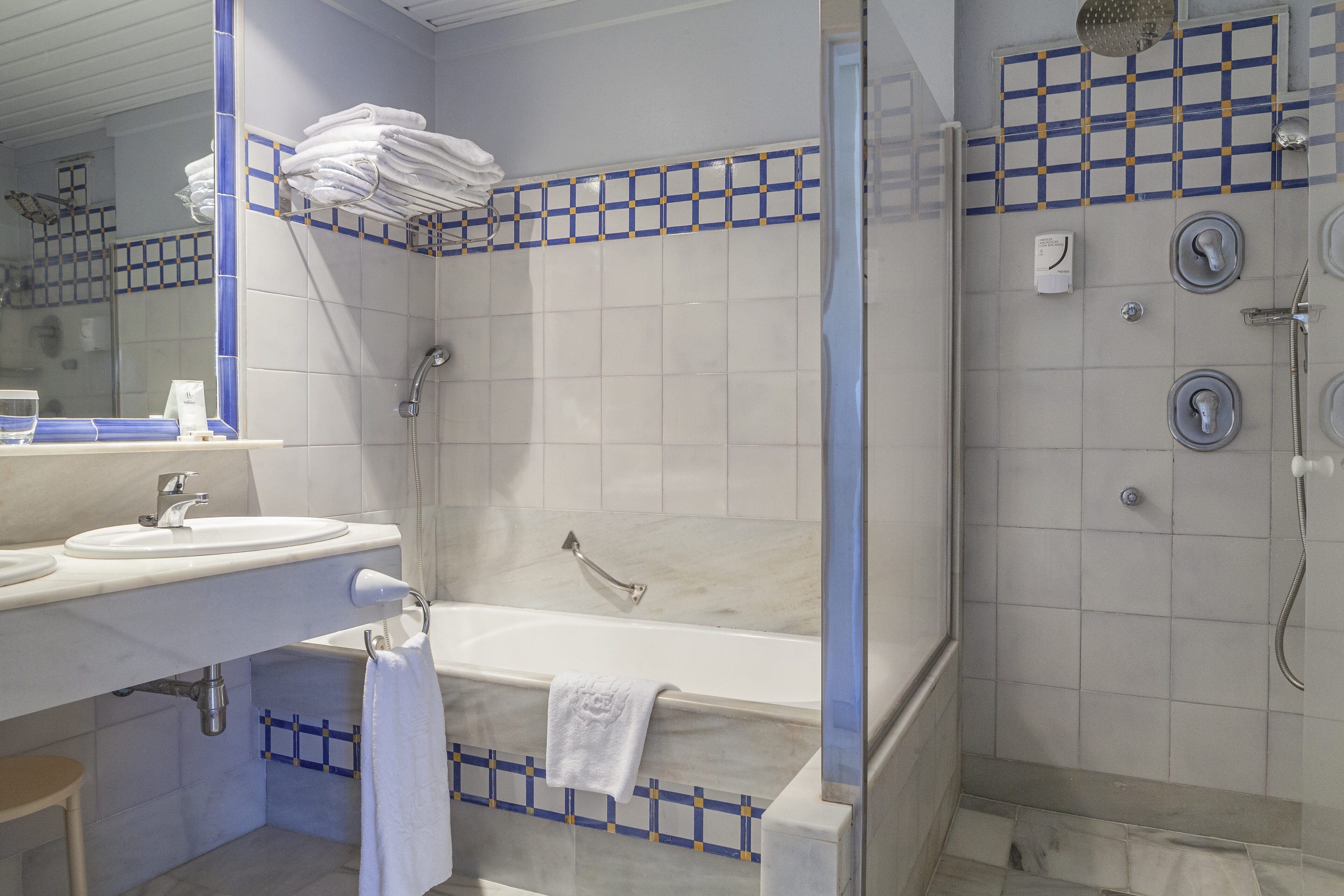 A bathroom with a bathtub, a shower, and a sink.