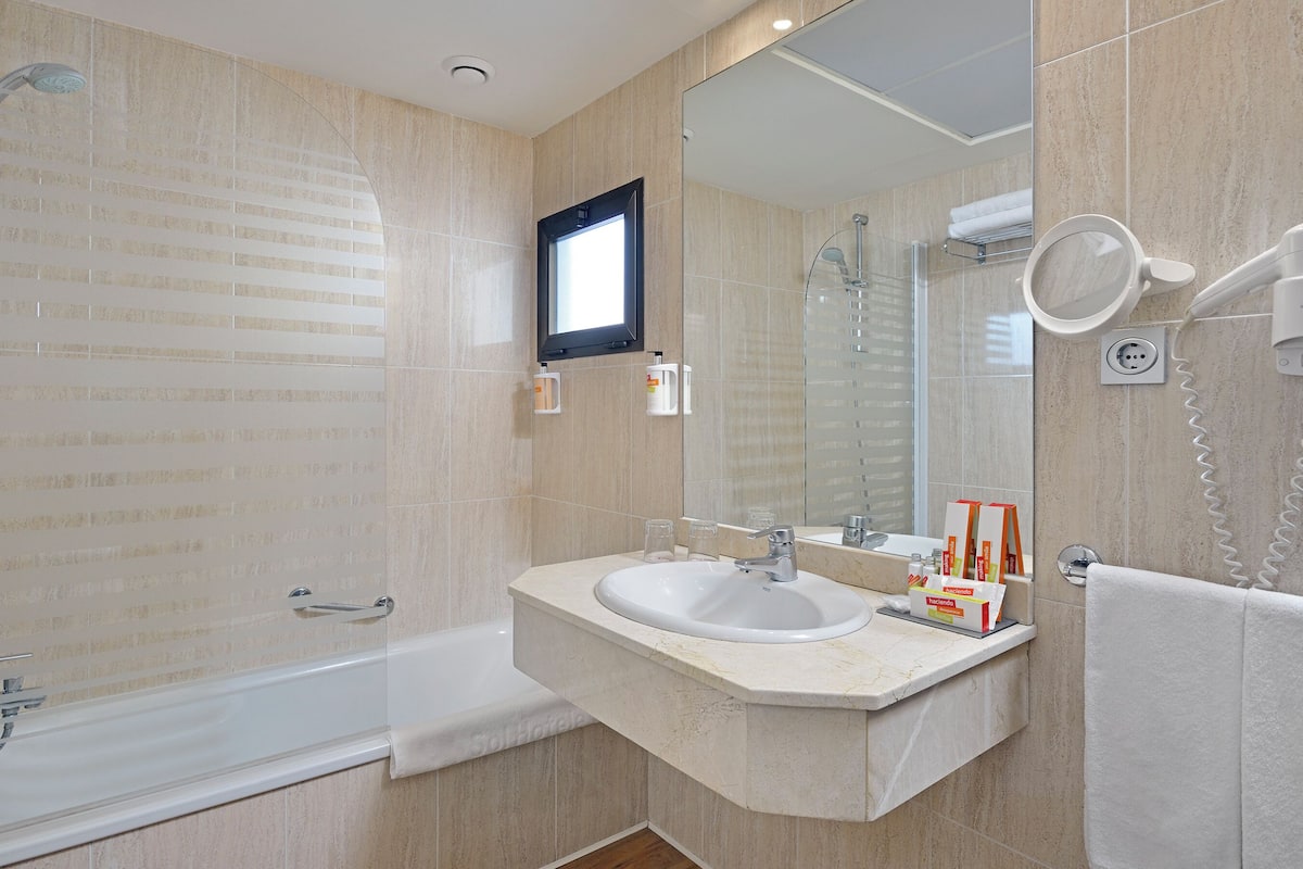 eco-friendly toiletries, hair dryer, towels, soap