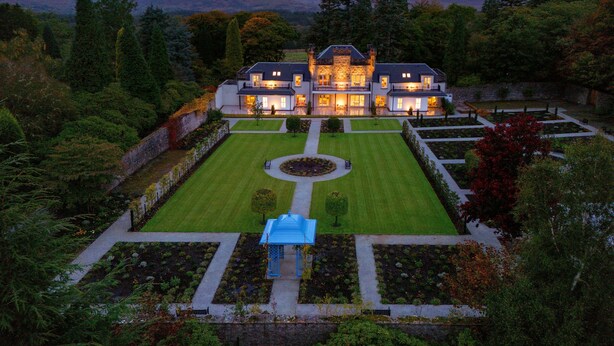 A large, historic house with a formal garden and a central lawn. - Inverlochy Castle (Fort William)