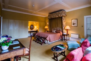 A hotel room with a bed, a desk, a chair, a small table, and a sofa. - Inverlochy Castle (Fort William)