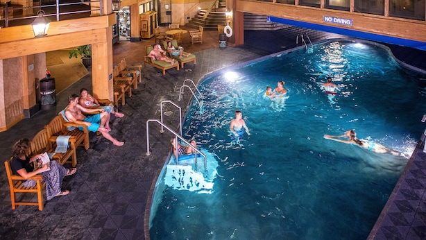 An indoor swimming pool with multiple people swimming and lounging. - Beaver Run Resort & Conference Center (Breckenridge)