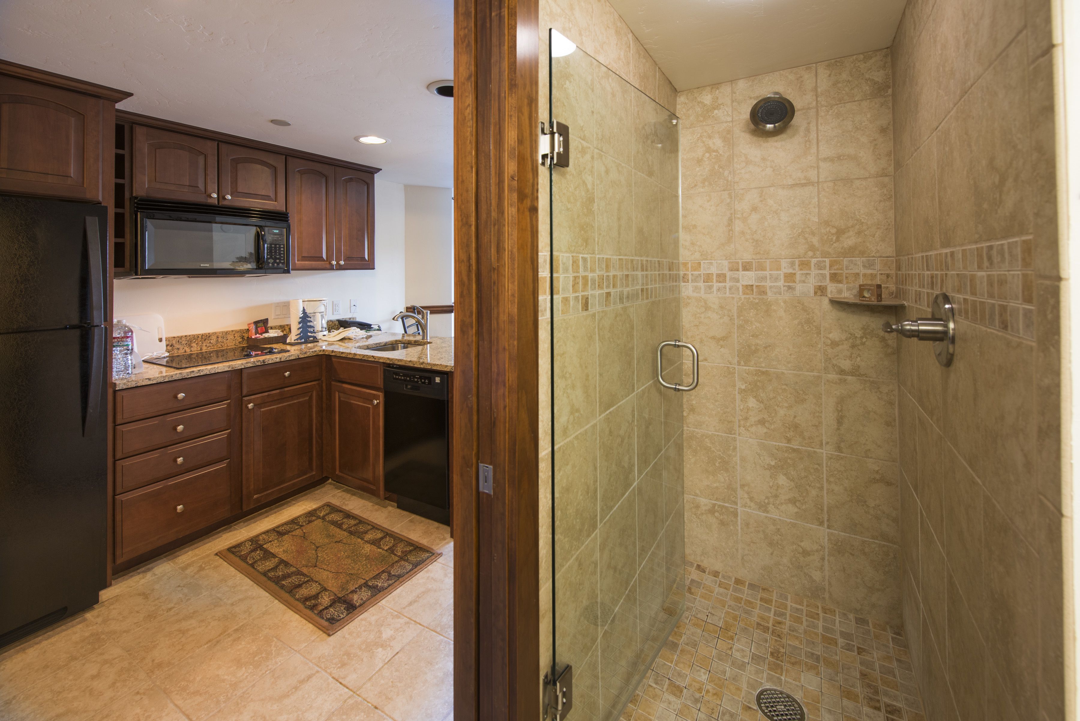 A kitchen with wooden cabinets, a microwave, and a dishwasher.