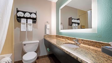 A bathroom with a toilet, sink, and towel rack.