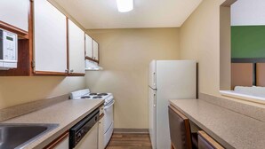 A compact kitchen with a stove, oven, dishwasher, and refrigerator. - Extended Stay America Select Suites Atlanta Alpharetta Norpt (Alpharetta)