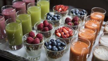 A variety of beverages and fruit bowls on a tray.