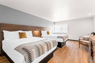 Ropa de cama hipoalergénica y espacio para trabajar con laptop