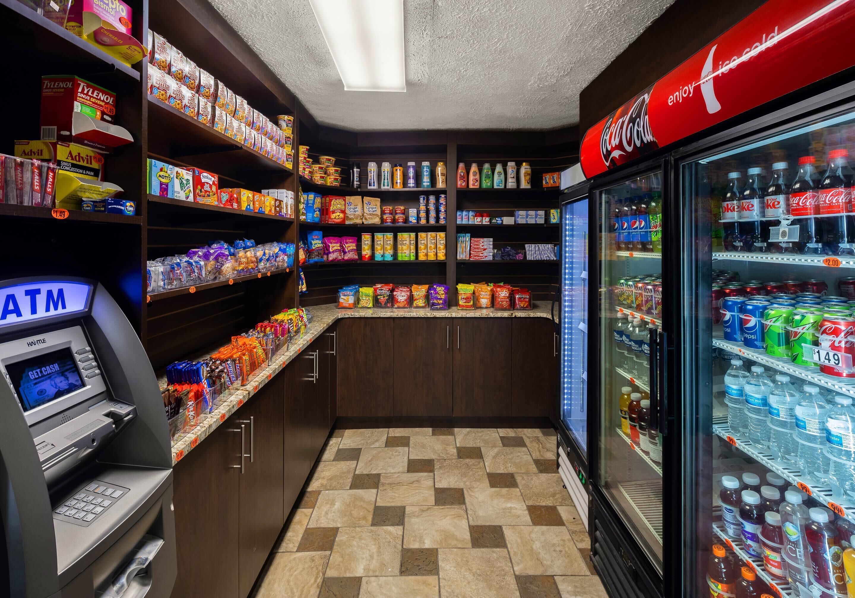 A self-service kiosk area with snacks, beverages, and an ATM.