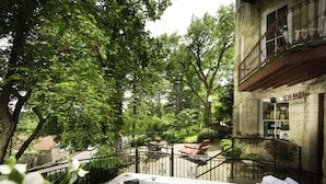 A spa area with a hot tub, outdoor seating, and a stone building labeled "NEW MON SALON". - The Crescent Hotel and Spa (Eureka Springs)