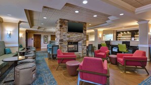 A spacious lobby with a stone fireplace, comfortable seating, and a reception area. - Hampton Inn Princeton (Princeton)