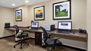 A hotel office with three desks, each with a computer and chair. - Hampton Inn Collinsville (Collinsville)
